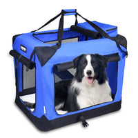 Blue soft-sided pet travel crate with mesh windows, three entry doors, carrying straps, and a black and white dog inside