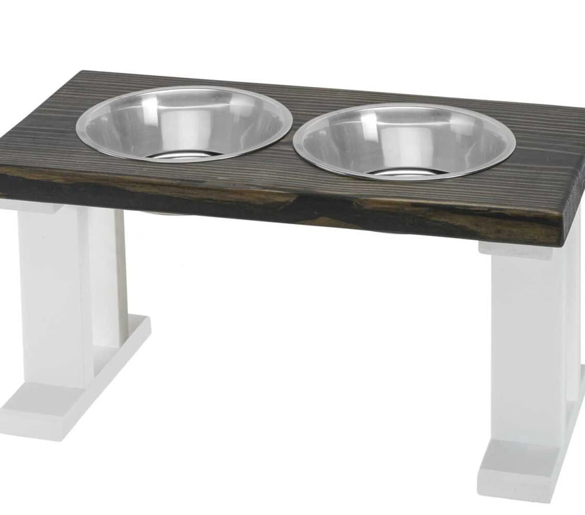 Farmhouse 2 Bowl Elevated wooden pet feeder with two stainless steel bowls on white legs.